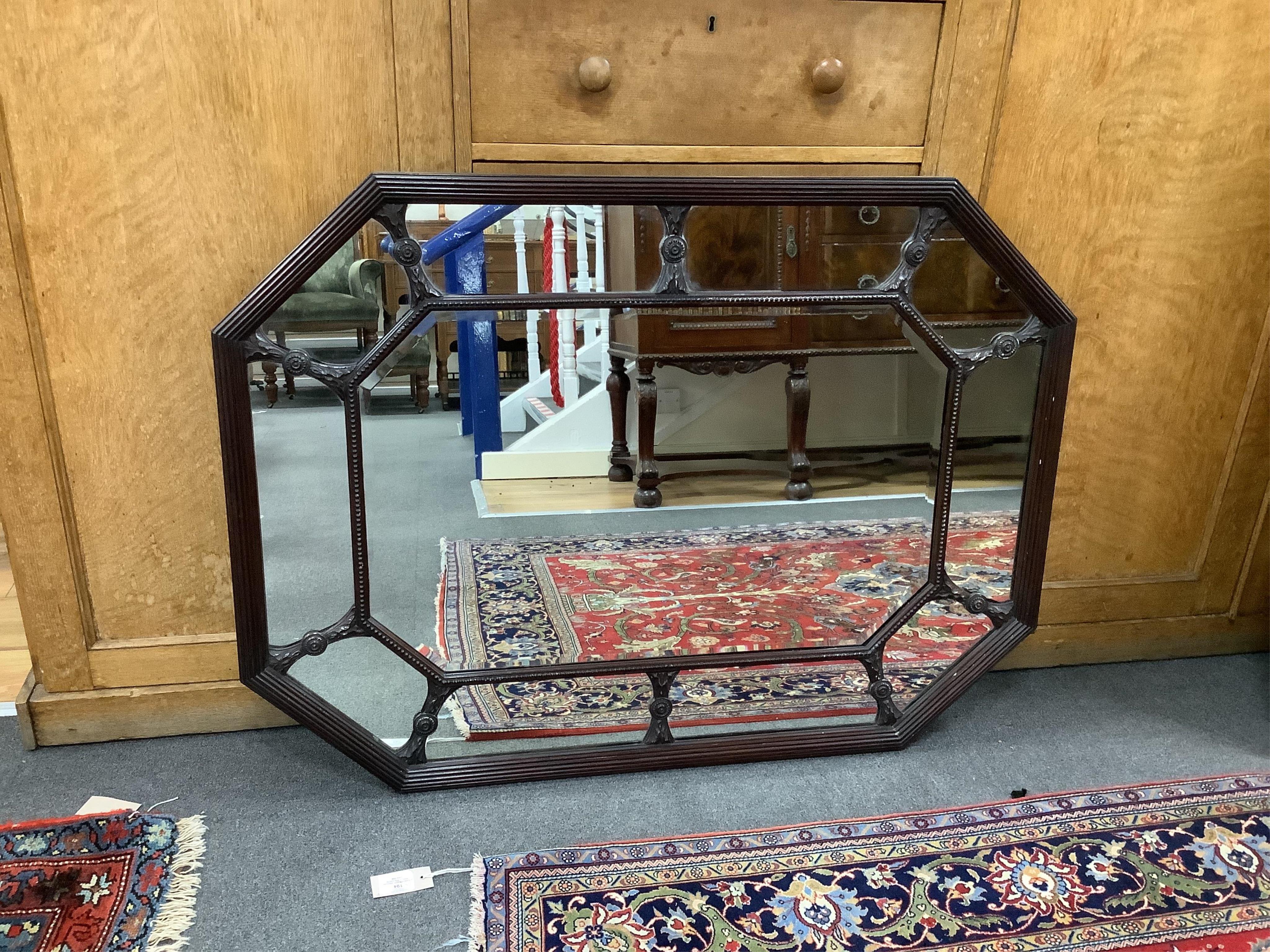 A George III style octagonal mahogany wall mirror, width 107cm, height 79cm. Condition - good